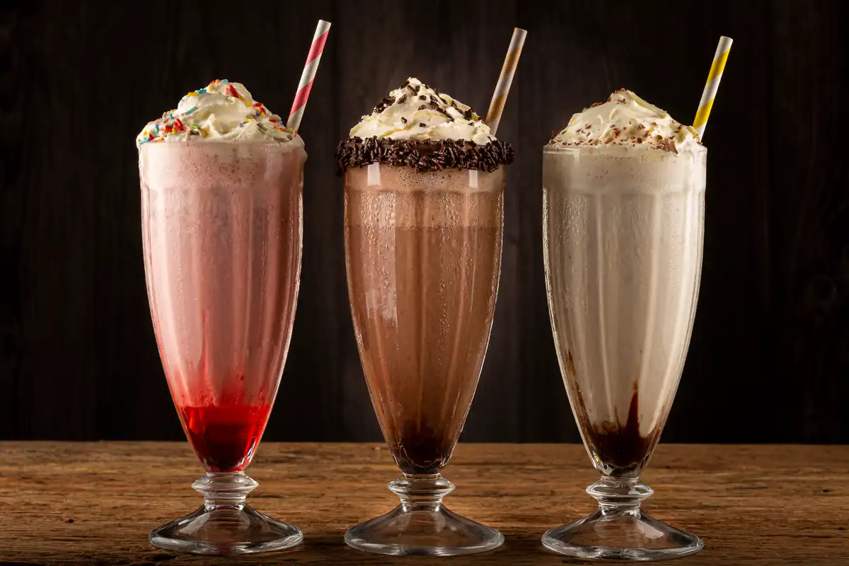 three-glasses-milkshake-with-assorted-flavors-chocolate-vanilla-strawberry-milkshake